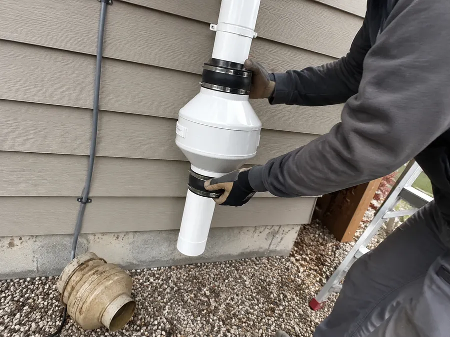 Replacing a radon mitigation fan on a Pueblo home exterior
